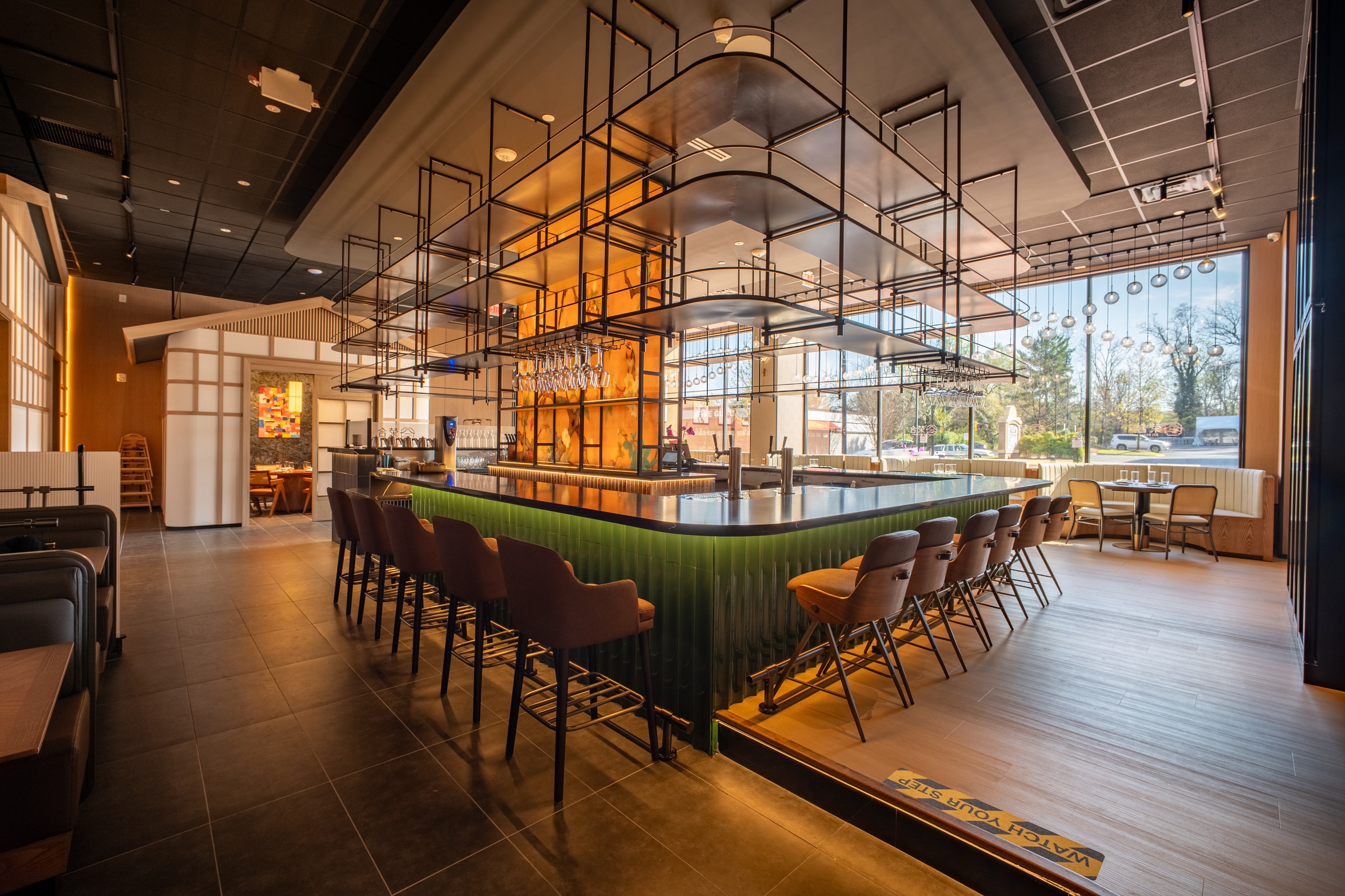 Tamu restaurant main bar with industrial shelving and amber backlight